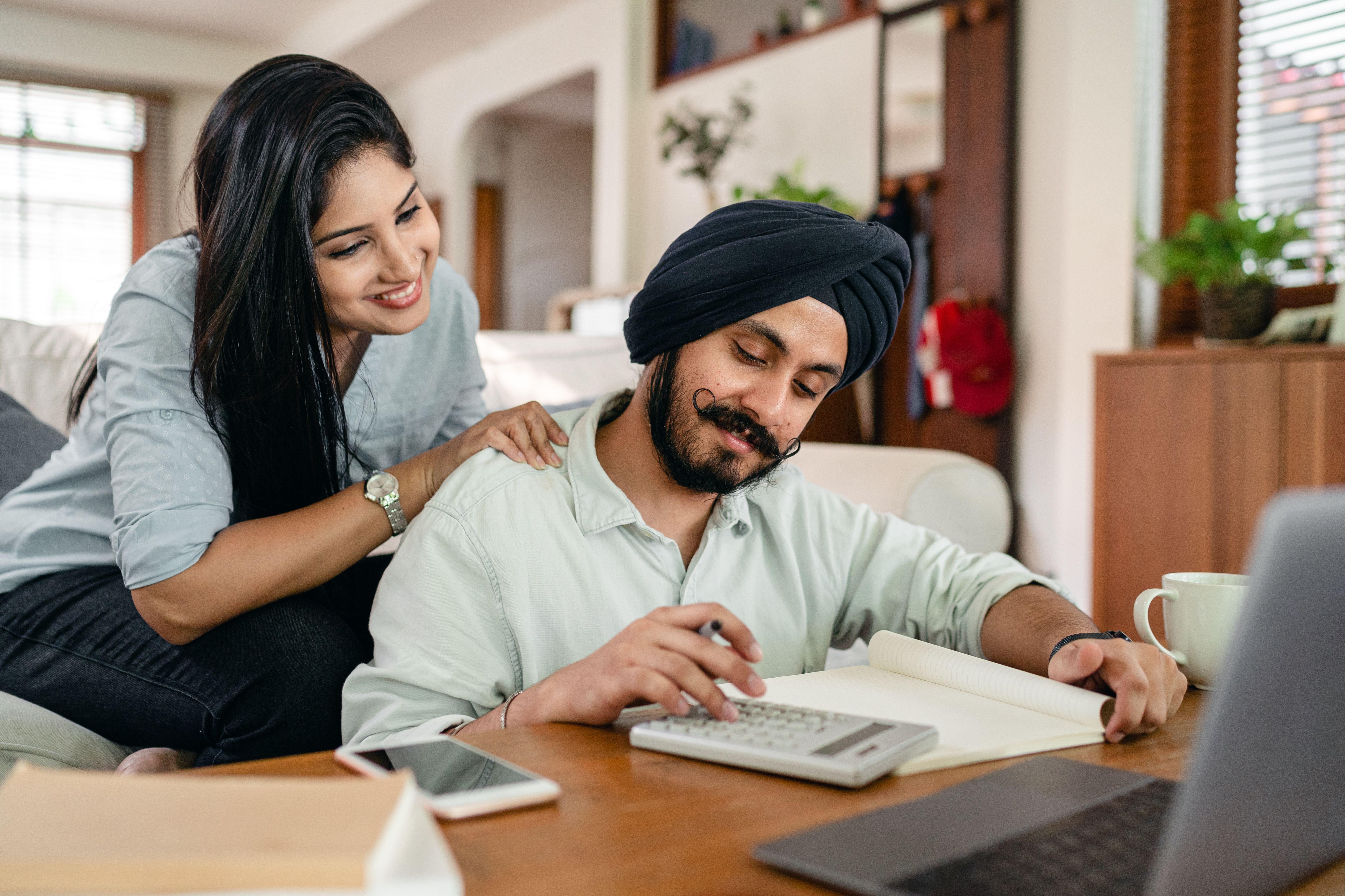 Indian professionals reviewing financial calculations and documents